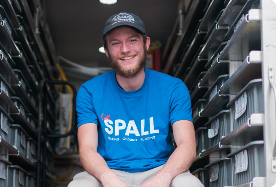 T.E. Spall & Son technician in the back of a fully stocked service van