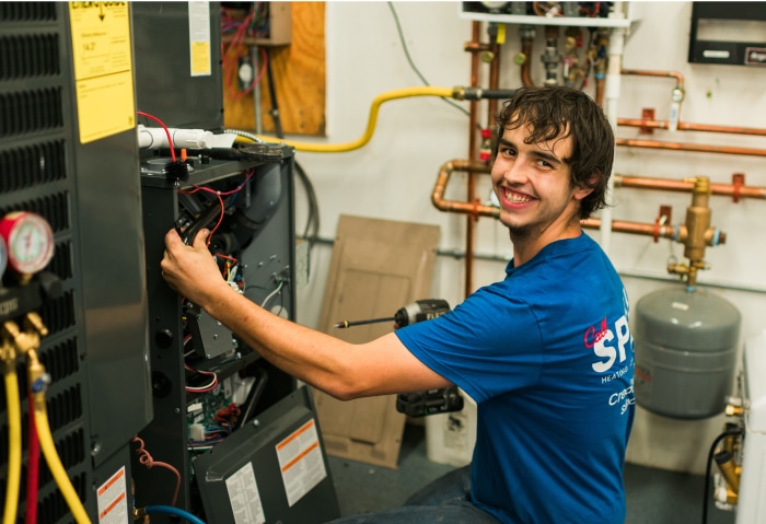 T.E. Spall & Son apprentice working on a furnace with gauges attached during hands-on training