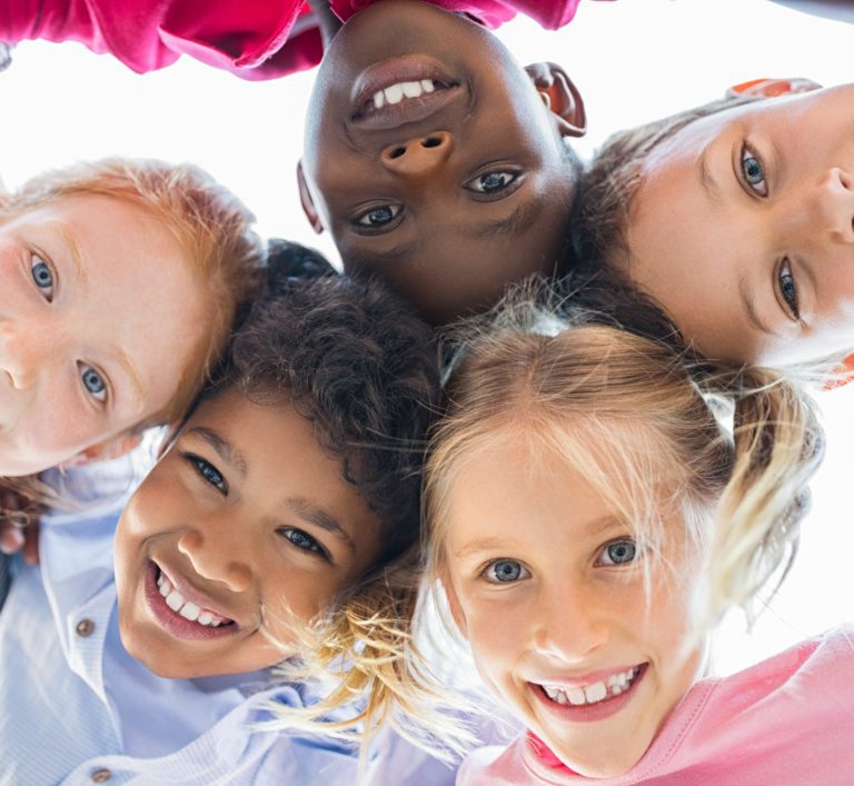 Closeup,Face,Of,Happy,Multiethnic,Children,Embracing,Each,Other,And
