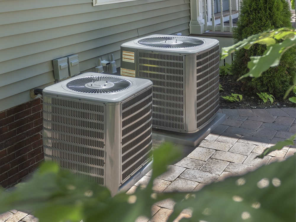 Two HVAC units outside a home.