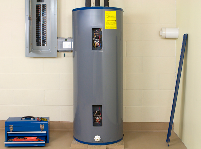 New electric water heater in the basement of a Pennsylvania home; toolbox setting on the floor next to the new system.