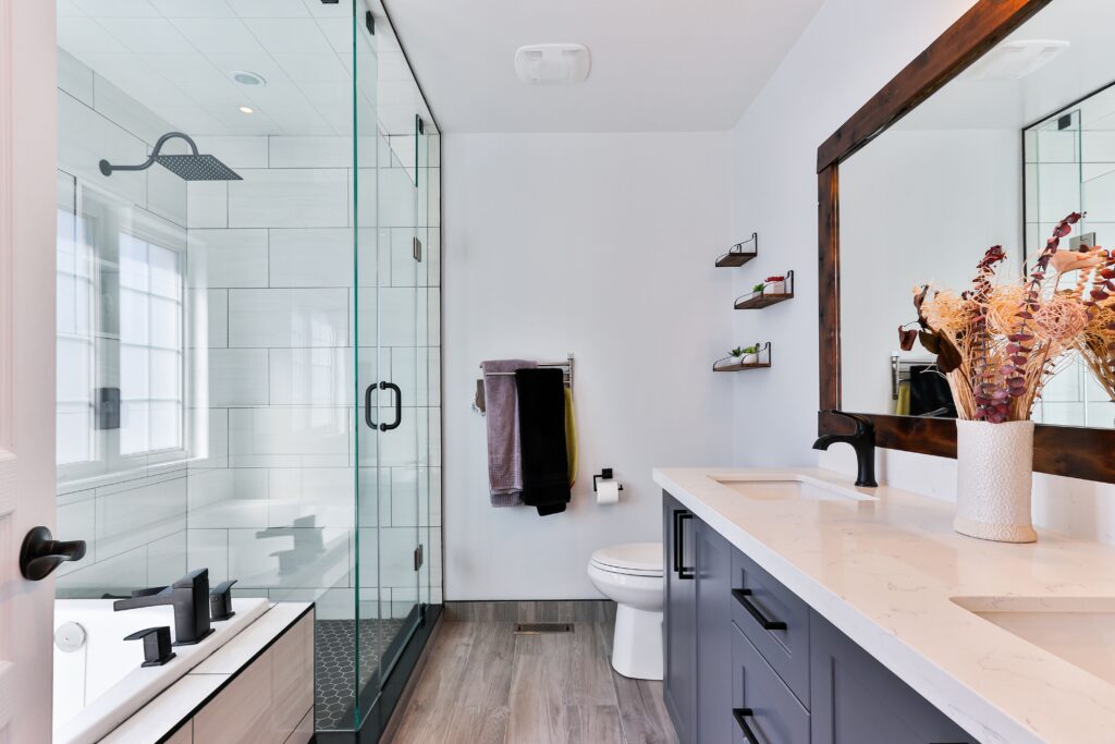 Modern bathroom with a large vanity, toilet, and walk-in shower.