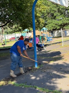 Weed trimming along the park fence line.